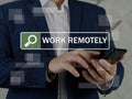 WORK REMOTELY text in search bar. Businessman looking for something at cellphone. Remote workÃÂ is aÃÂ workingÃÂ style that allows